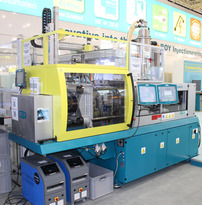 Two Injection Moulding Machines at Plast Milan: a Small Giant and a Big Dwarf.
