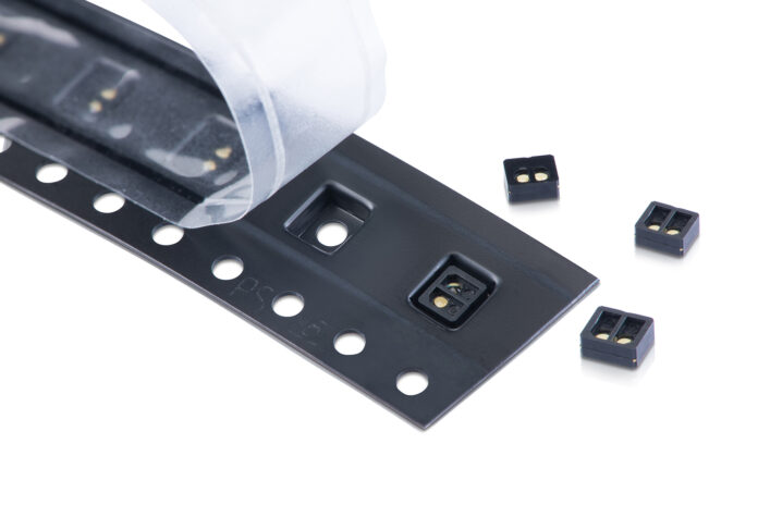 Reel-to-reel overmolded time-of-flight sensor lens made from EXTEM resin.